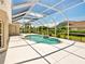 Sun-drenched screened pool with ample patio space, lush landscaping, and views of the neighborhood at 1136 Deardon Dr, Venice, FL 34292