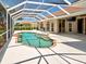 Spacious screened pool area with lush landscaping, offering a private oasis for leisure and entertaining at 1136 Deardon Dr, Venice, FL 34292