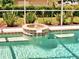 Tranquil pool featuring a decorative fountain and steps for easy access, surrounded by lush, green landscaping at 1136 Deardon Dr, Venice, FL 34292