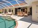 Gorgeous screened-in pool area with dining and lounging spaces, perfect for relaxing and entertaining outdoors at 1136 Deardon Dr, Venice, FL 34292