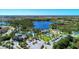 High aerial view of a vibrant community with a lake, playground, pool, and walking trails at 11739 Okaloosa Dr, Venice, FL 34293