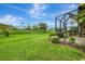 Expansive backyard with a well-maintained lawn and view of the screened in patio at 11739 Okaloosa Dr, Venice, FL 34293