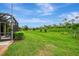 Expansive backyard with lush greenery and a screened-in patio, perfect for enjoying the outdoors at 11739 Okaloosa Dr, Venice, FL 34293