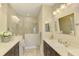 Well-lit bathroom featuring double sinks, and a spacious glass shower with stylish accents at 11739 Okaloosa Dr, Venice, FL 34293