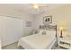 Cozy bedroom with a decorative iron bed frame, neutral tones, and a closet for storage at 11739 Okaloosa Dr, Venice, FL 34293