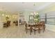 Open concept dining room with seating for six, views into the kitchen and lots of natural light at 11739 Okaloosa Dr, Venice, FL 34293