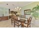 Dining room with wood table and chairs, a view into the kitchen, and decor lighting at 11739 Okaloosa Dr, Venice, FL 34293