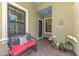 Charming front porch featuring a cozy bench and decorative plants at 11739 Okaloosa Dr, Venice, FL 34293