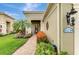 Inviting home featuring lush landscaping, a brick walkway, and exterior lighting at 11739 Okaloosa Dr, Venice, FL 34293