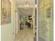 Inviting foyer with tile flooring, a decorative light fixture, and a clear view into the kitchen at 11739 Okaloosa Dr, Venice, FL 34293