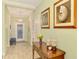 Elegant foyer with tile flooring, shell art, and a view of the front door at 11739 Okaloosa Dr, Venice, FL 34293
