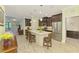 Modern kitchen featuring an island with barstool seating and stainless steel appliances at 11739 Okaloosa Dr, Venice, FL 34293