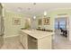 Island in the kitchen with a stainless dishwasher and a sink with a view into a sitting room at 11739 Okaloosa Dr, Venice, FL 34293
