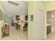 Open-concept kitchen featuring an island with barstool seating and stainless steel appliances at 11739 Okaloosa Dr, Venice, FL 34293