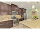 Spacious kitchen with an island, stainless steel appliances, granite counters, and a tile backsplash for easy maintenance at 11739 Okaloosa Dr, Venice, FL 34293