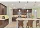 Beautiful kitchen with a large island, stainless appliances, and dark wood cabinetry, perfect for cooking and entertaining at 11739 Okaloosa Dr, Venice, FL 34293