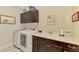 Well-equipped laundry room with washer, dryer, storage cabinets, and a utility sink at 11739 Okaloosa Dr, Venice, FL 34293