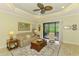 Inviting living room with comfortable seating, neutral tones, and a seamless connection to the outdoor space at 11739 Okaloosa Dr, Venice, FL 34293