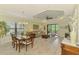 Open-concept living room and dining area with lots of natural light and views of the lush backyard at 11739 Okaloosa Dr, Venice, FL 34293