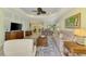Open-concept living space showcasing a modern TV setup and smooth transition to the dining area at 11739 Okaloosa Dr, Venice, FL 34293