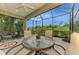 Screened patio with a table and chairs, offering an inviting space for outdoor dining at 11739 Okaloosa Dr, Venice, FL 34293