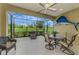 Relaxing screened-in patio with comfortable seating and views of the lush green landscape at 11739 Okaloosa Dr, Venice, FL 34293