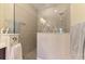 Modern walk-in shower with pebbled floor, towel bar, and clear glass partition, providing a spa-like experience at 11739 Okaloosa Dr, Venice, FL 34293