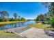 Picturesque view of the lakefront with a kayak launch at 11739 Okaloosa Dr, Venice, FL 34293