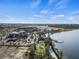 Aerial view of a modern community surrounding a lake, featuring green spaces, parks, and walking trails at 11819 Tempest Harbor Loop, Venice, FL 34292