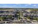 Sweeping aerial view of a Primary-planned community with modern apartments and tree-lined streets at 11819 Tempest Harbor Loop, Venice, FL 34292