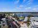 Aerial view of a community street with sidewalks, a blue playground, and a scenic lake at 11819 Tempest Harbor Loop, Venice, FL 34292