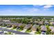 Expansive aerial view captures a well-developed residential community with mature trees and a vibrant mix of home styles at 11819 Tempest Harbor Loop, Venice, FL 34292