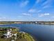 Breathtaking aerial view of a community by the lake, showcasing palm trees and waterfront views at 11819 Tempest Harbor Loop, Venice, FL 34292