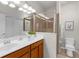 Bright bathroom featuring double sinks, a glass shower enclosure, and neutral tile at 11819 Tempest Harbor Loop, Venice, FL 34292