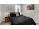 Comfortable bedroom featuring a black bed set with wooden night stands at 11819 Tempest Harbor Loop, Venice, FL 34292