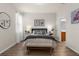 Bright bedroom with gray accents, wood floors, and ensuite bathroom access at 11819 Tempest Harbor Loop, Venice, FL 34292