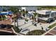Aerial view of a commercial district with various businesses, outdoor seating, and well-kept landscaping at 11819 Tempest Harbor Loop, Venice, FL 34292