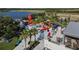 Aerial view of a commercial area with a mix of eateries, including shipping container restaurants, and lakeside views at 11819 Tempest Harbor Loop, Venice, FL 34292