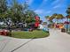 Community area with chairs, lush green lawn, and lakeside food and drink stands on a sunny day at 11819 Tempest Harbor Loop, Venice, FL 34292