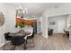 Open dining area with a chandelier, wood floors, and access to the kitchen and living spaces at 11819 Tempest Harbor Loop, Venice, FL 34292