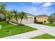 Charming one-story home boasts a manicured lawn, lush landscaping, and a convenient two-car garage at 11819 Tempest Harbor Loop, Venice, FL 34292
