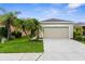 Charming single-Gathering home with a two-car garage, well-maintained lawn, and attractive landscaping at 11819 Tempest Harbor Loop, Venice, FL 34292