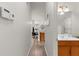 Hallway leading to a dining area and bathroom with updated fixtures at 11819 Tempest Harbor Loop, Venice, FL 34292