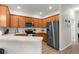 Contemporary kitchen featuring stainless steel appliances, wood cabinets, and plenty of counter space at 11819 Tempest Harbor Loop, Venice, FL 34292