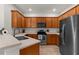 Modern kitchen with stainless steel appliances, ample cabinet space, and a large countertop at 11819 Tempest Harbor Loop, Venice, FL 34292