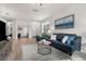 Bright and spacious living room with wood floors, modern furnishings, and an abundance of natural light at 11819 Tempest Harbor Loop, Venice, FL 34292