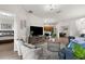 Bright and airy living room with wood floors, modern décor, and an open layout leading to the kitchen at 11819 Tempest Harbor Loop, Venice, FL 34292