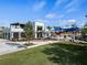 Exterior of the Oak and Stone restaurant with outdoor seating and a lush lawn area at 11819 Tempest Harbor Loop, Venice, FL 34292
