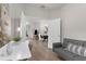 Home office with a futon and desk that flows to dining and living areas at 11819 Tempest Harbor Loop, Venice, FL 34292