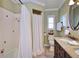 Bathroom featuring a shower with a white curtain, toilet, and vanity with granite countertops at 1198 Jamaica Rd, Venice, FL 34293